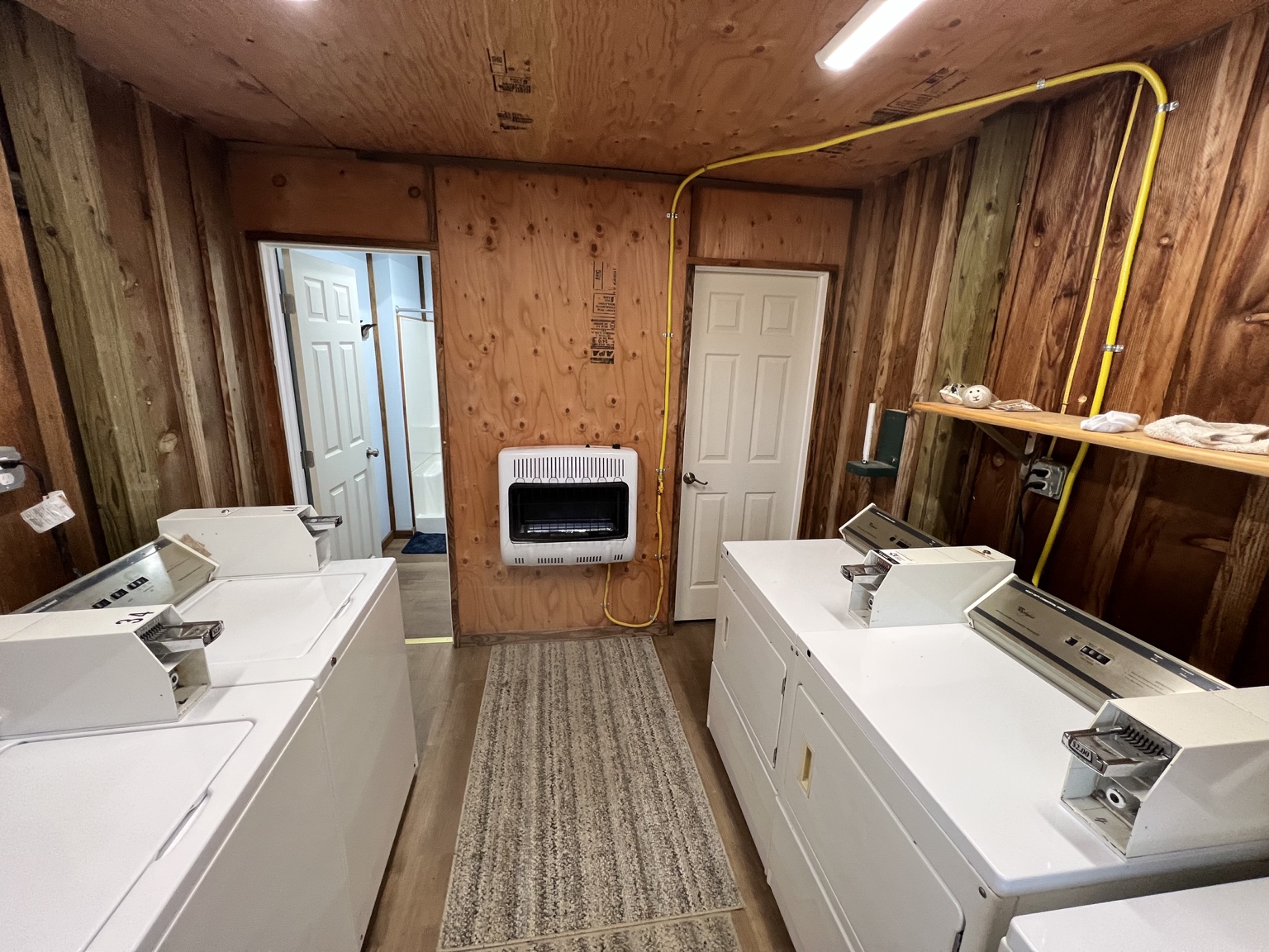 Albatross laundry room with washing machines and dryers, beside the shower rooms